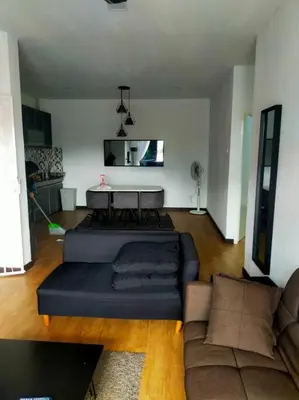 a living room with a couch and a table at Omar's place 4 - Best view of KLCC Twin Towers. in Kuala Lumpur