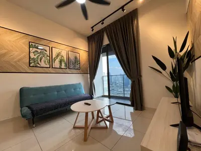 a living room with a couch and a table at Infini Suites@ Continew Residence KL in Kuala Lumpur