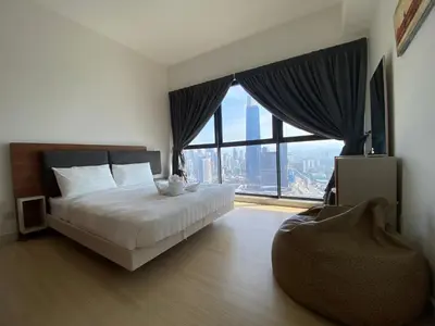 a bedroom with a bed and a large window at Infini Suites@ Continew Residence KL in Kuala Lumpur