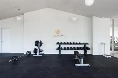 a gym with dumbbells and weights in a room at UNA Serviced Apartment, Sunway Velocity Kuala Lumpur in Kuala Lumpur