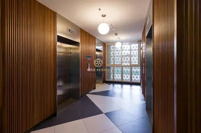 a hallway with wooden walls and a tile floor at UNA Serviced Apartment, Sunway Velocity Kuala Lumpur in Kuala Lumpur