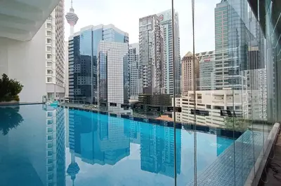 a swimming pool in a city with tall buildings at A05 Bukit Ceylon KL Tower View Balcony Apartment in Kuala Lumpur