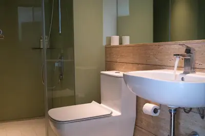 a bathroom with a sink and a toilet and a shower at Atmoods - Vortex KLCC in Kuala Lumpur