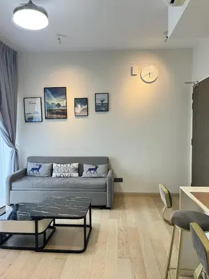 a living room with a couch and a clock on the wall at Atmoods - Star Residence in Kuala Lumpur