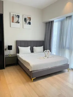 a bedroom with a bed with two swans on it at Atmoods - Star Residence in Kuala Lumpur