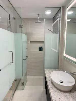 a bathroom with a sink and a glass shower at Atmoods - Star Residence in Kuala Lumpur