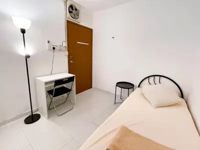 a bedroom with a bed and a desk and a lamp at Tiong Nam 32, Heart of Kuala Lumpur, 15mins to KLCC, 6 mins to LRT PWTC in Kuala Lumpur