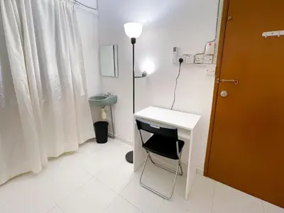 a room with a desk and a table and a lamp at Tiong Nam 32, Heart of Kuala Lumpur, 15mins to KLCC, 6 mins to LRT PWTC in Kuala Lumpur