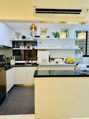 a kitchen with white cabinets and a black counter top at Charming apartment with Netflix at PWTC in Kuala Lumpur