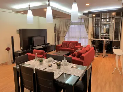 a living room with red furniture and a tv at Bukit Bintang Fahrenheit88 Apartment by Sarah's Lodge in Kuala Lumpur