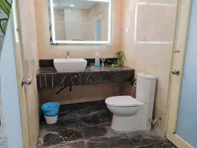 a bathroom with a sink and a toilet and a mirror at Bukit Bintang Fahrenheit88 Apartment by Sarah's Lodge in Kuala Lumpur