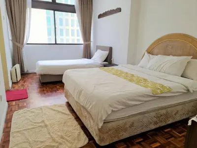 a bedroom with two beds and a large window at Bukit Bintang Fahrenheit88 Apartment by Sarah's Lodge in Kuala Lumpur