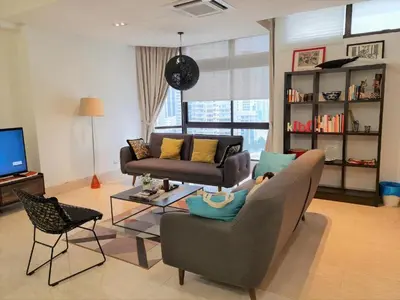 a living room with a couch and a chair at Bukit Bintang Fahrenheit88 Apartment by Sarah's Lodge in Kuala Lumpur