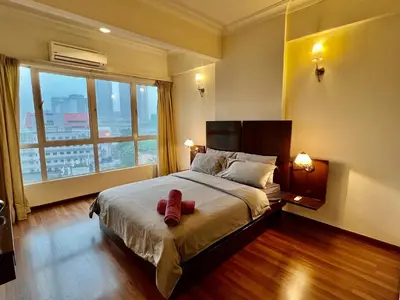 a bedroom with a bed with two red shoes on it at Casa Mutiara Apartments by Moonlight in Kuala Lumpur