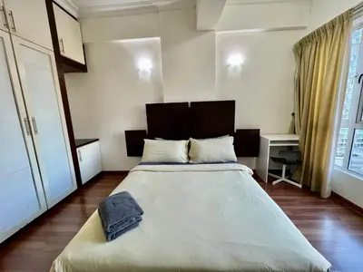 a bedroom with a large bed in a room at Casa Mutiara Apartments by Moonlight in Kuala Lumpur