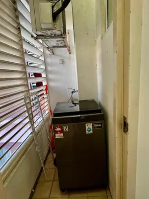 a small refrigerator in a room next to a window at Casa Mutiara Apartments by Moonlight in Kuala Lumpur