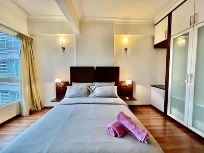 a bedroom with a large bed with pink towels on it at Casa Mutiara Apartments by Moonlight in Kuala Lumpur