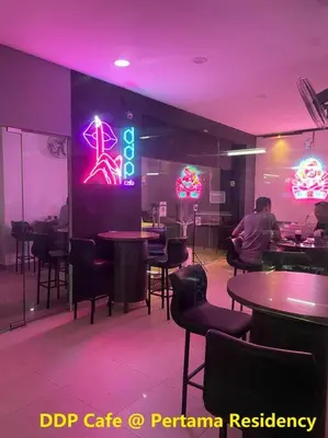 a restaurant with tables and chairs and a neon sign at Staycation with Private Jacuzzi @ KL Downtown 1711 in Kuala Lumpur