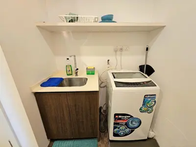 a small kitchen with a sink and a refrigerator at KLCC Binjai 8 Premium Soho Apartment by Sarah's Lodge in Kuala Lumpur