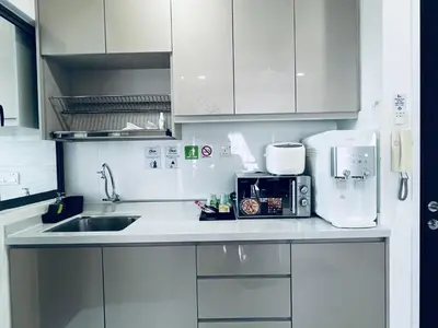 a kitchen with a sink and a microwave at Kama Homestay @Wangsa Maju in Kuala Lumpur