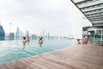 a group of people in the infinity pool of a building at La Vista @ Regalia Residence in Kuala Lumpur