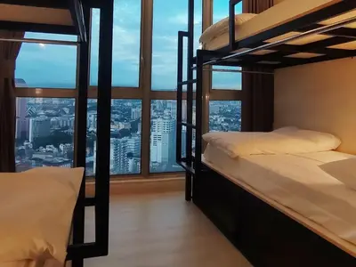 two bunk beds in a room with a large window at La Vista @ Regalia Residence in Kuala Lumpur