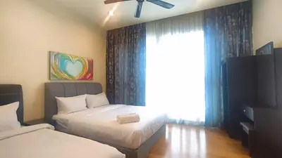 a bedroom with two beds and a window at La Vista @ Regalia Residence in Kuala Lumpur