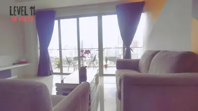 a living room with two couches and a large window at La Vista @ Regalia Residence in Kuala Lumpur