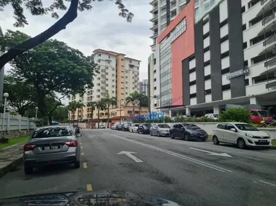 a street with cars parked on the side of the road at Romantic Suite with Private Jacuzzi 176 in Kuala Lumpur