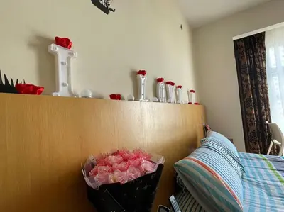a bunch of roses in a trash can next to a bed at Romantic Suite with Private Jacuzzi 176 in Kuala Lumpur