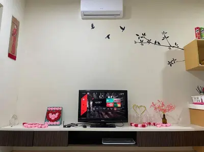 a tv sitting on a table with birds on the wall at Romantic Suite with Private Jacuzzi 176 in Kuala Lumpur