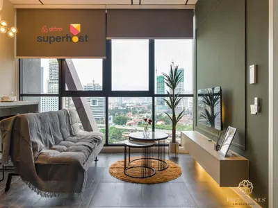 a living room with a couch and a large window at Scarletz Suites Kuala Lumpur, Five Senses in Kuala Lumpur