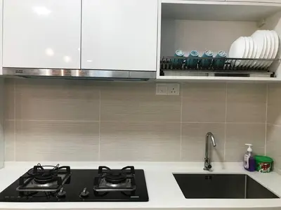 a kitchen with two stove tops and a sink at KLCC VIEW-3 BED LOVELY APARTMENTS IN KUALA LUMPUR in Kuala Lumpur
