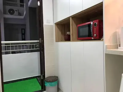 a microwave sitting on top of a cabinet in a kitchen at KLCC VIEW-3 BED LOVELY APARTMENTS IN KUALA LUMPUR in Kuala Lumpur