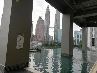 a view of a river in a city with tall buildings at KLCC VIEW-3 BED LOVELY APARTMENTS IN KUALA LUMPUR in Kuala Lumpur