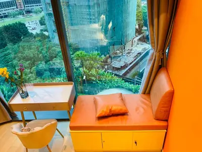 a room with a window with a bench and a desk at Eaton residences KLCC m@h in Kuala Lumpur