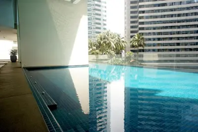 a swimming pool in a building with tall buildings at Bukit Bintang KLCC Binjai 8 Premium Soho Apartment by Sarah's Lodge in Kuala Lumpur