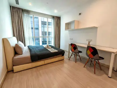 a bedroom with a bed and a desk and two chairs at Bukit Bintang KLCC Binjai 8 Premium Soho Apartment by Sarah's Lodge in Kuala Lumpur