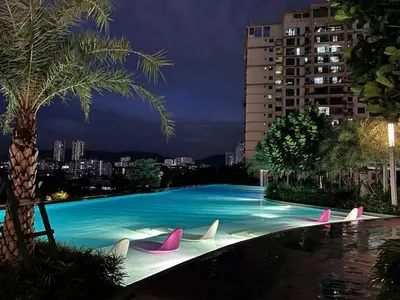 a large swimming pool with pink and white chairs at PARC 3 in Cheras, #Sunway Velocity #IKEA #TRX in Kuala Lumpur