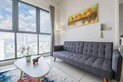 a living room with a couch and a table at Cozy Oasis near Ikea TRX Mall King Size Bed 100mb in Kuala Lumpur