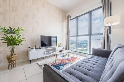 a living room with a couch and a tv at Cozy Oasis near Ikea TRX Mall King Size Bed 100mb in Kuala Lumpur