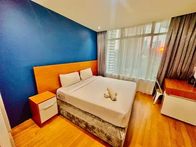 a bedroom with a bed with a teddy bear on it at near klcc vortex suites by PLUS POIN in Kuala Lumpur