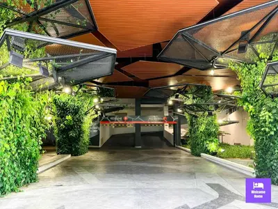 a room with a table and some plants at Continew Residences TRX Lux Pool View in Kuala Lumpur
