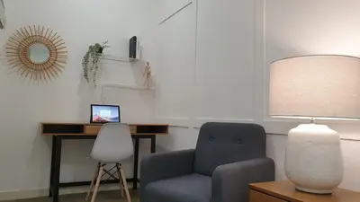 a living room with a chair and a desk at Mont Kiara 163 Mall (The Ooak) Private Room in Kuala Lumpur
