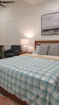a bedroom with a bed with a checkered blanket at Mont Kiara 163 Mall (The Ooak) Private Room in Kuala Lumpur