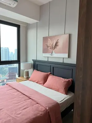 a bedroom with a bed with pink sheets and a window at Mont Kiara 163 Mall (The Ooak) Private Room in Kuala Lumpur