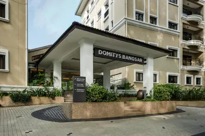 a building with a sign that reads donuts sandwich at Domitys Bangsar Kuala Lumpur in Kuala Lumpur