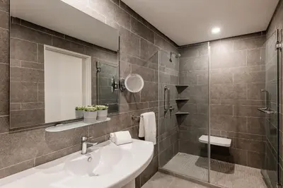 a bathroom with a sink and a shower at Domitys Bangsar Kuala Lumpur in Kuala Lumpur