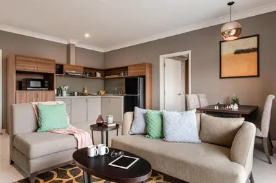 a living room with a couch and a table at Domitys Bangsar Kuala Lumpur in Kuala Lumpur