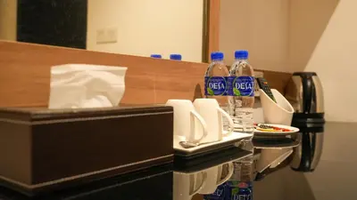a hotel room with bottles of water on a counter at D Loft Hotel in Kuala Lumpur